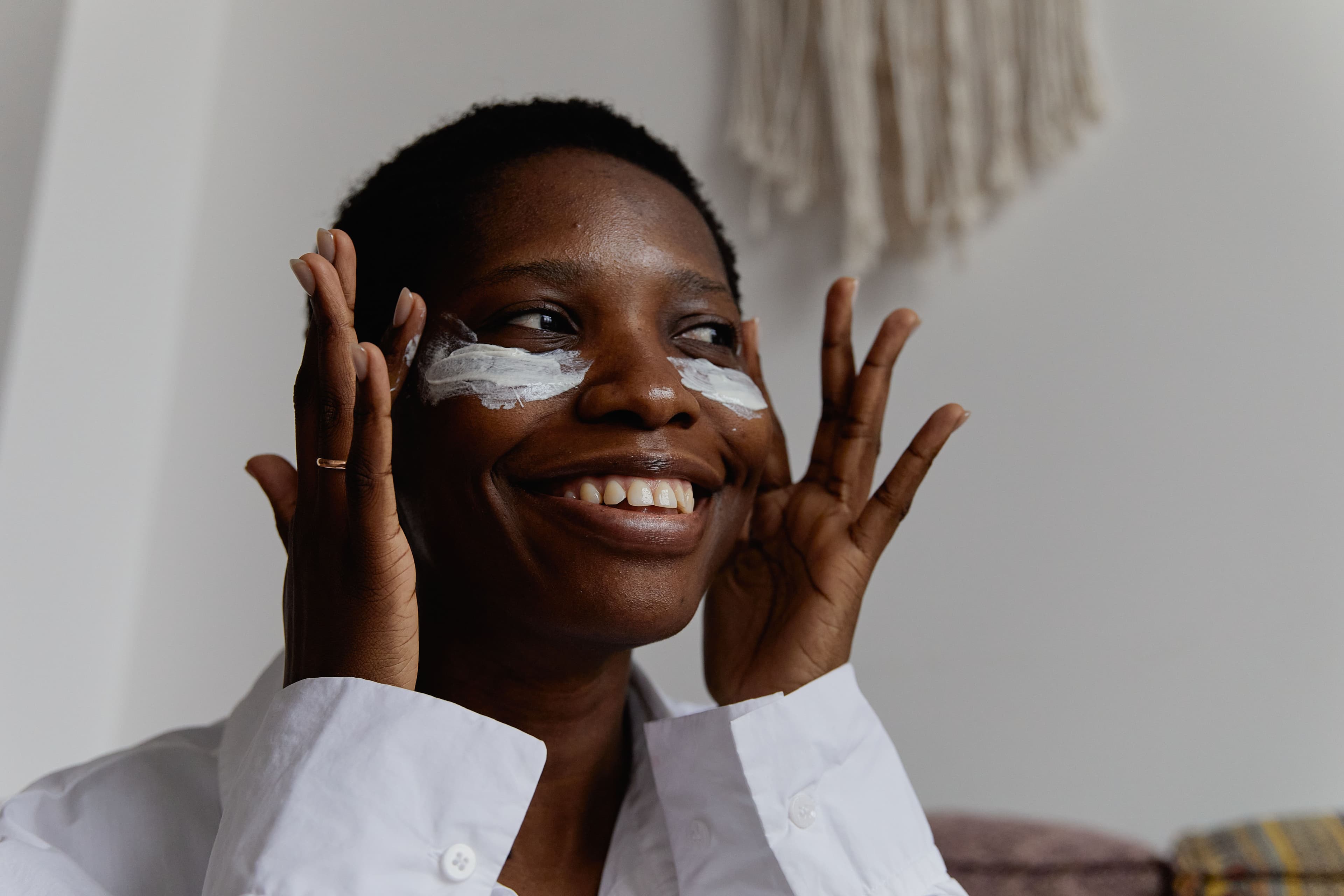 Woman applying skincare to her face