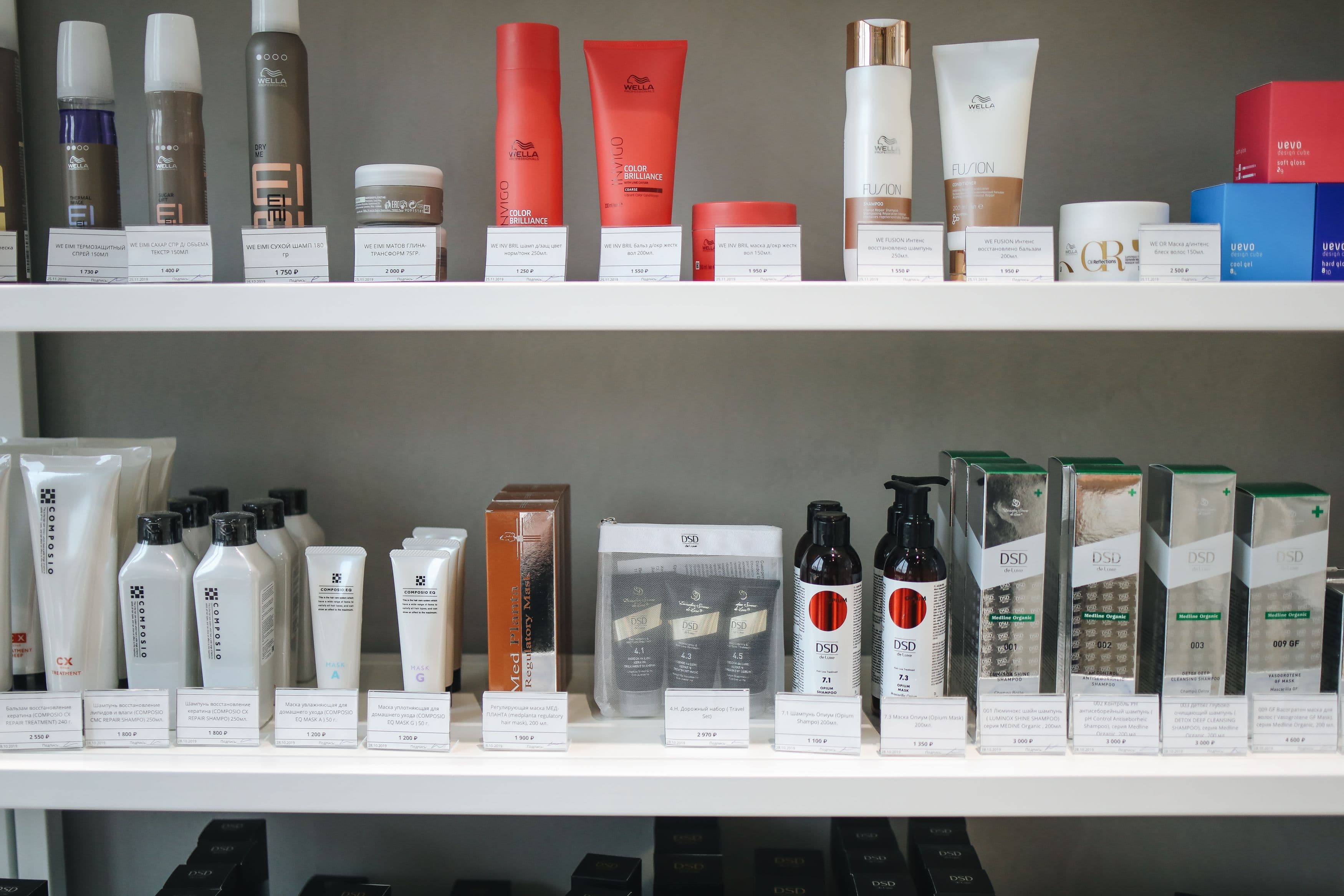Nigerian beauty retailer reviewing stock while holding a skincare product
