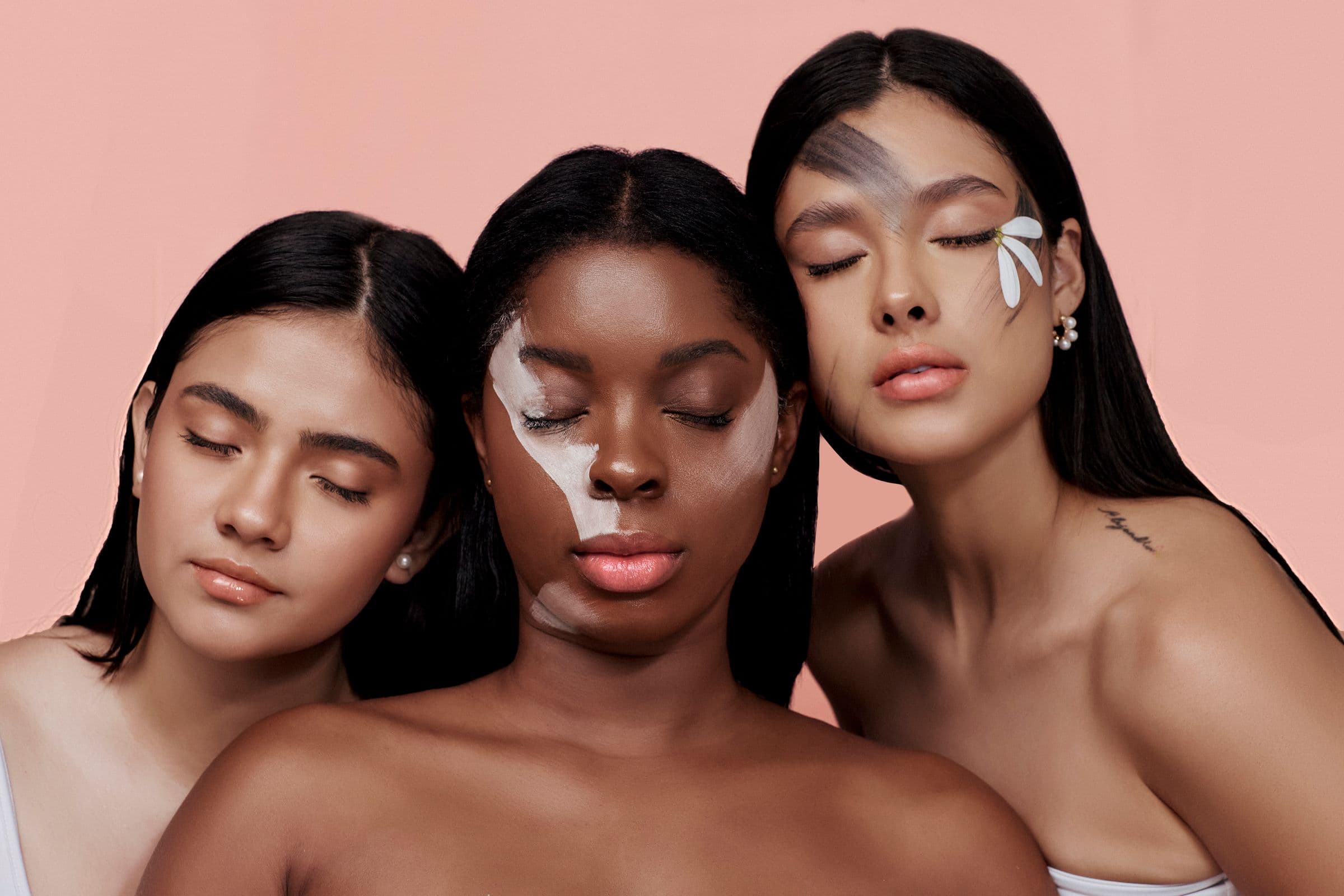 Three women with eyes closed in a skincare portrait